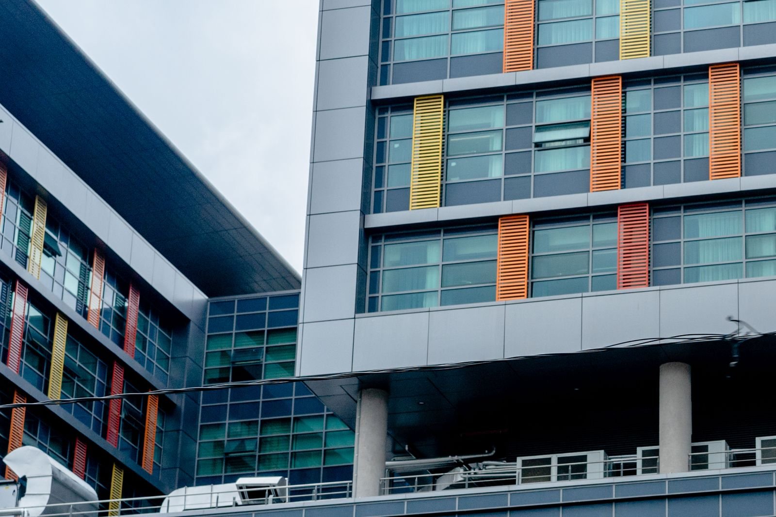 Modern glass and panel building with coloured window bands