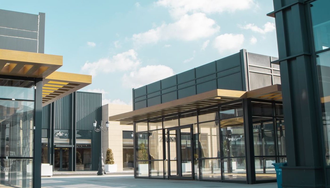 Modern retail plaza storefronts with covered walkways