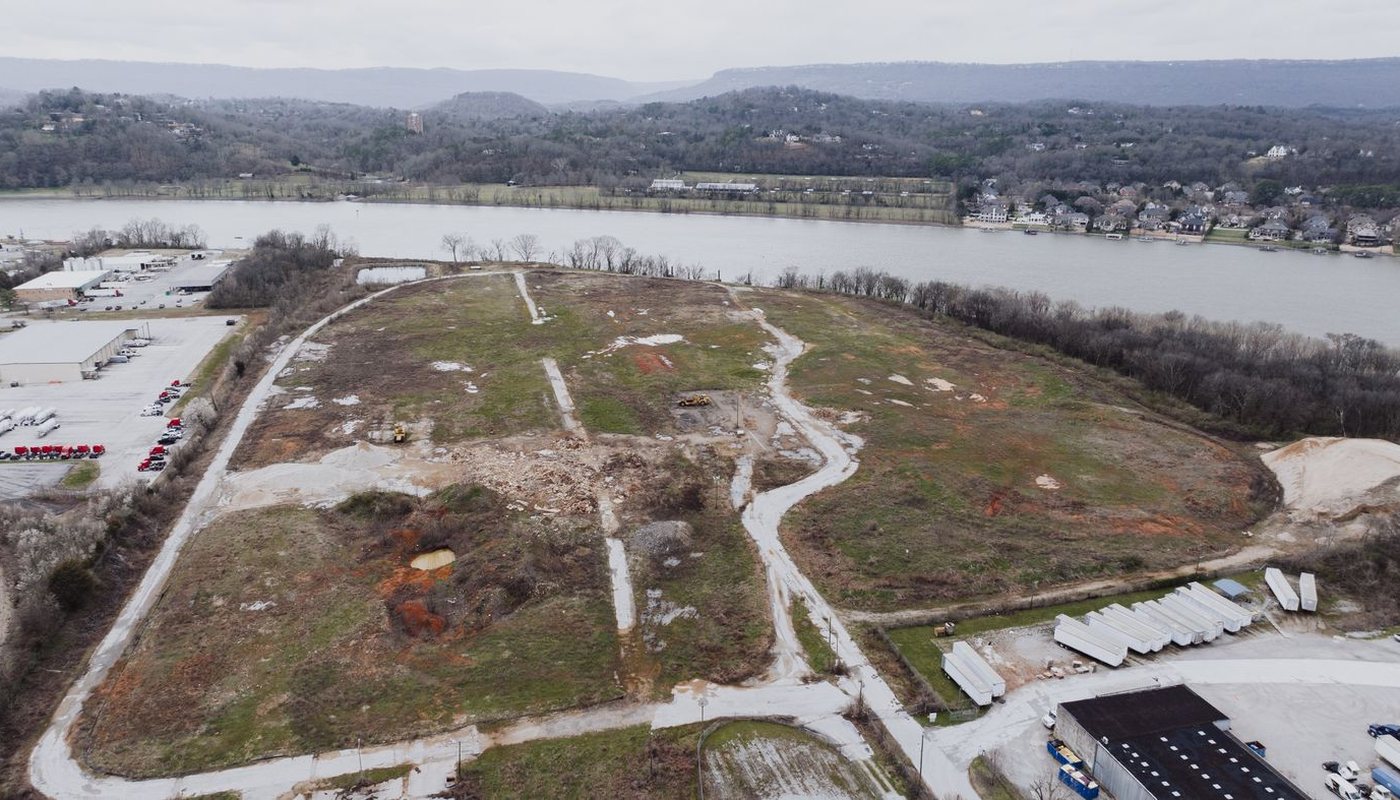 Aerial view of a cleared development site beside a river
