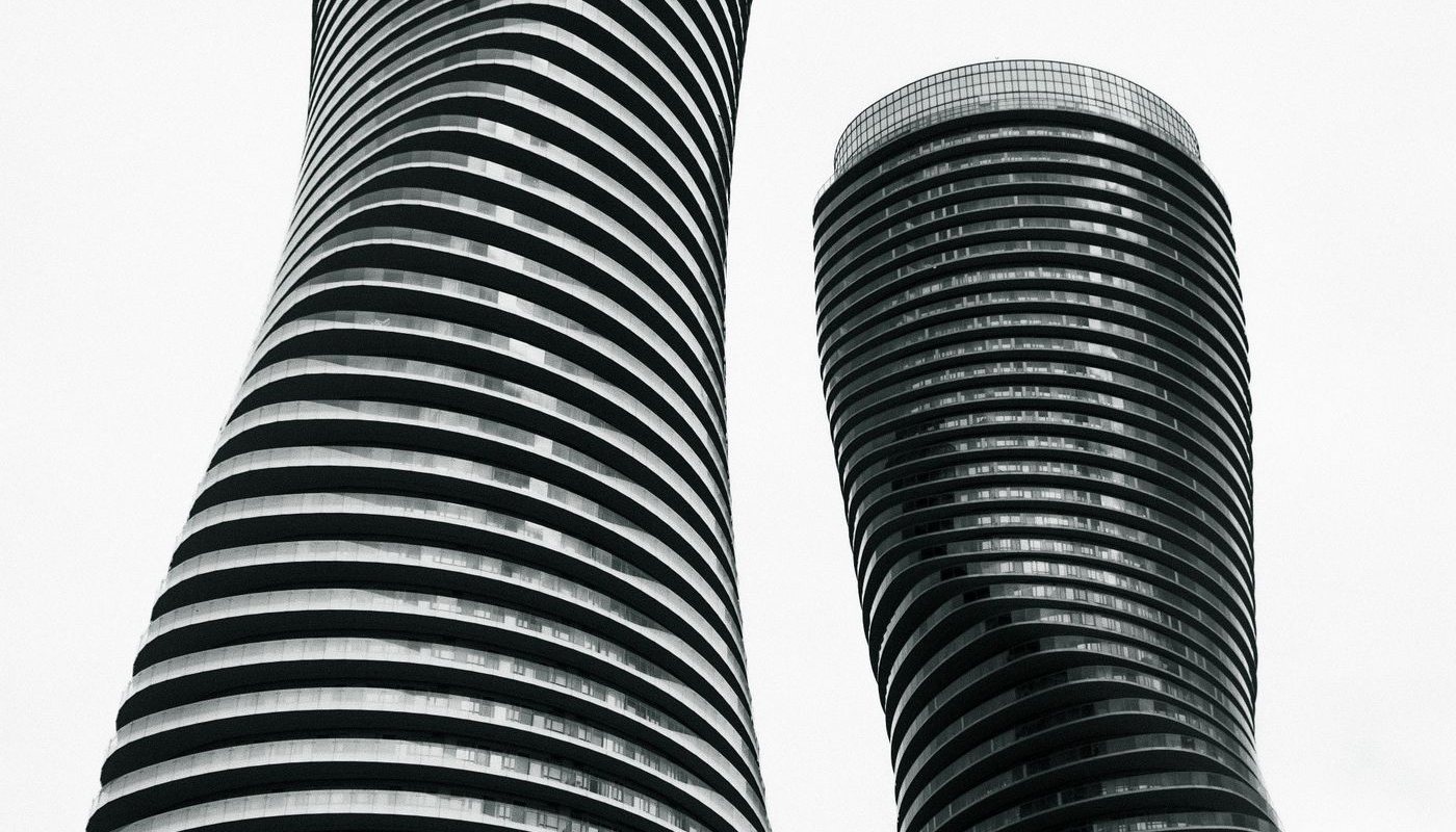 Absolute World twin towers in Mississauga against a white sky