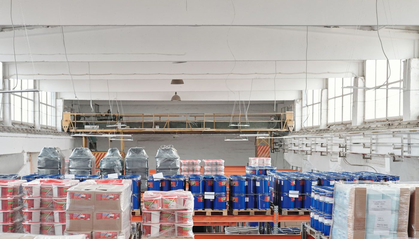 Bright industrial warehouse interior with palletized goods