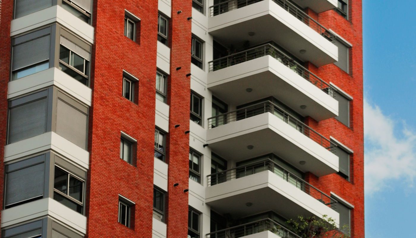 Red brick apartment tower with balconies